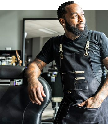 Lifestyle. Barber smiling by chair.
