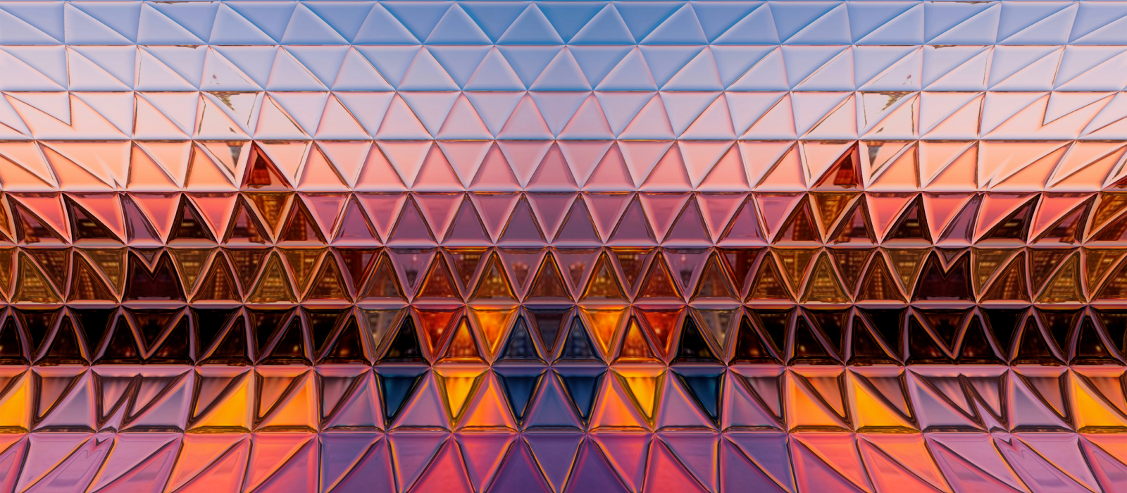 Decorative. Close-up view of colorful geometric glass surface reflecting the city skyline.