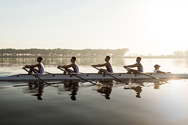 Men’s rowing team glides across a body of water