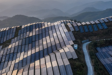 Solar panels situated across an expansive group of mountain ranges
